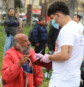 street medicine worker with male patient street medicine worker helping patient